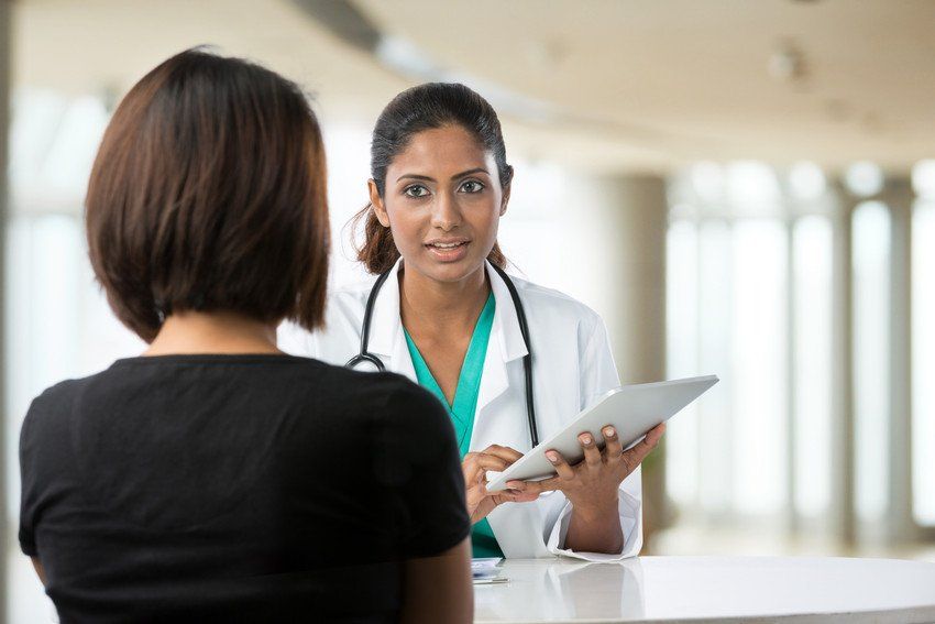 Doctor talking to woman