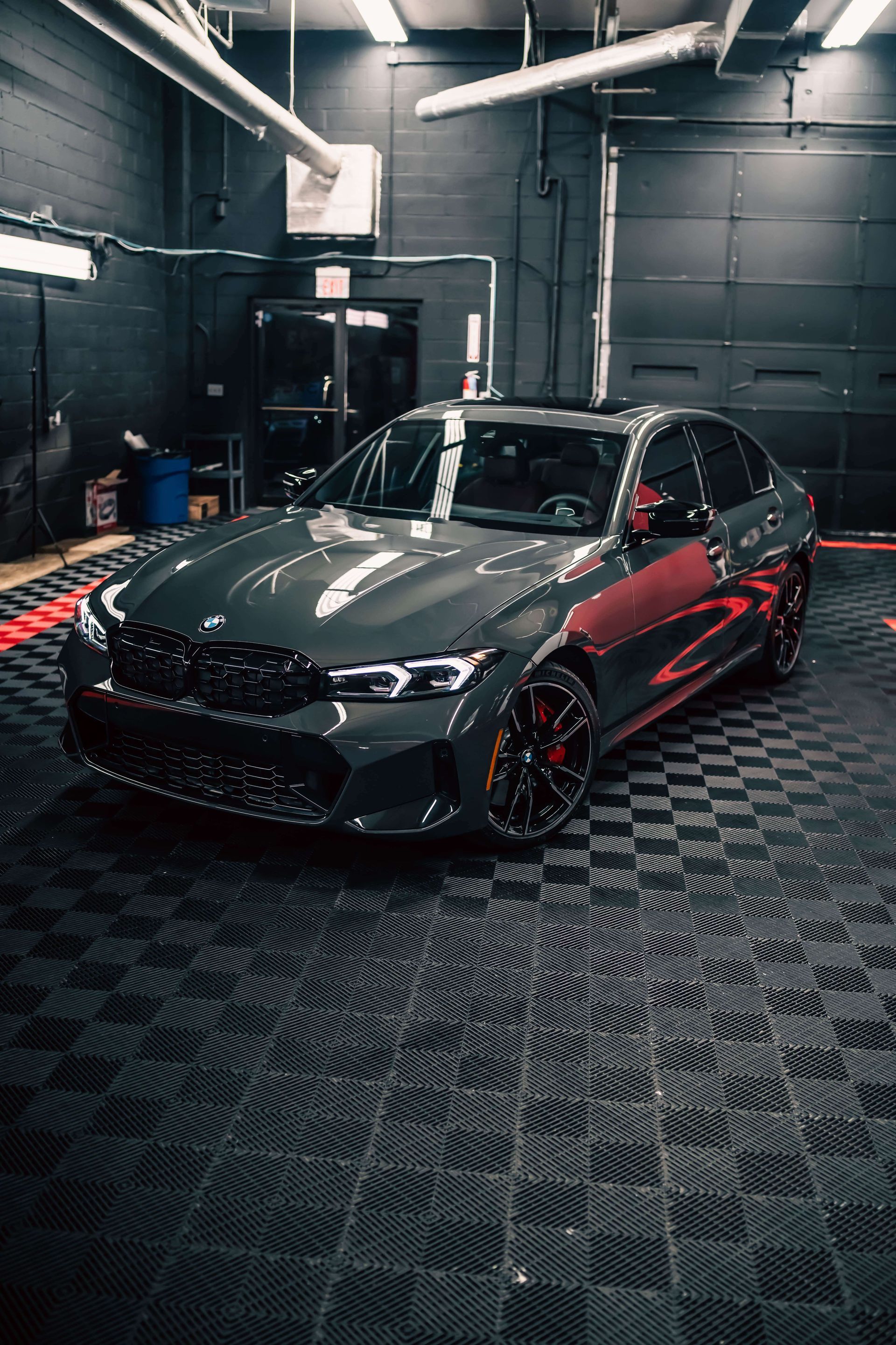 A bmw 3 series is parked in a garage.