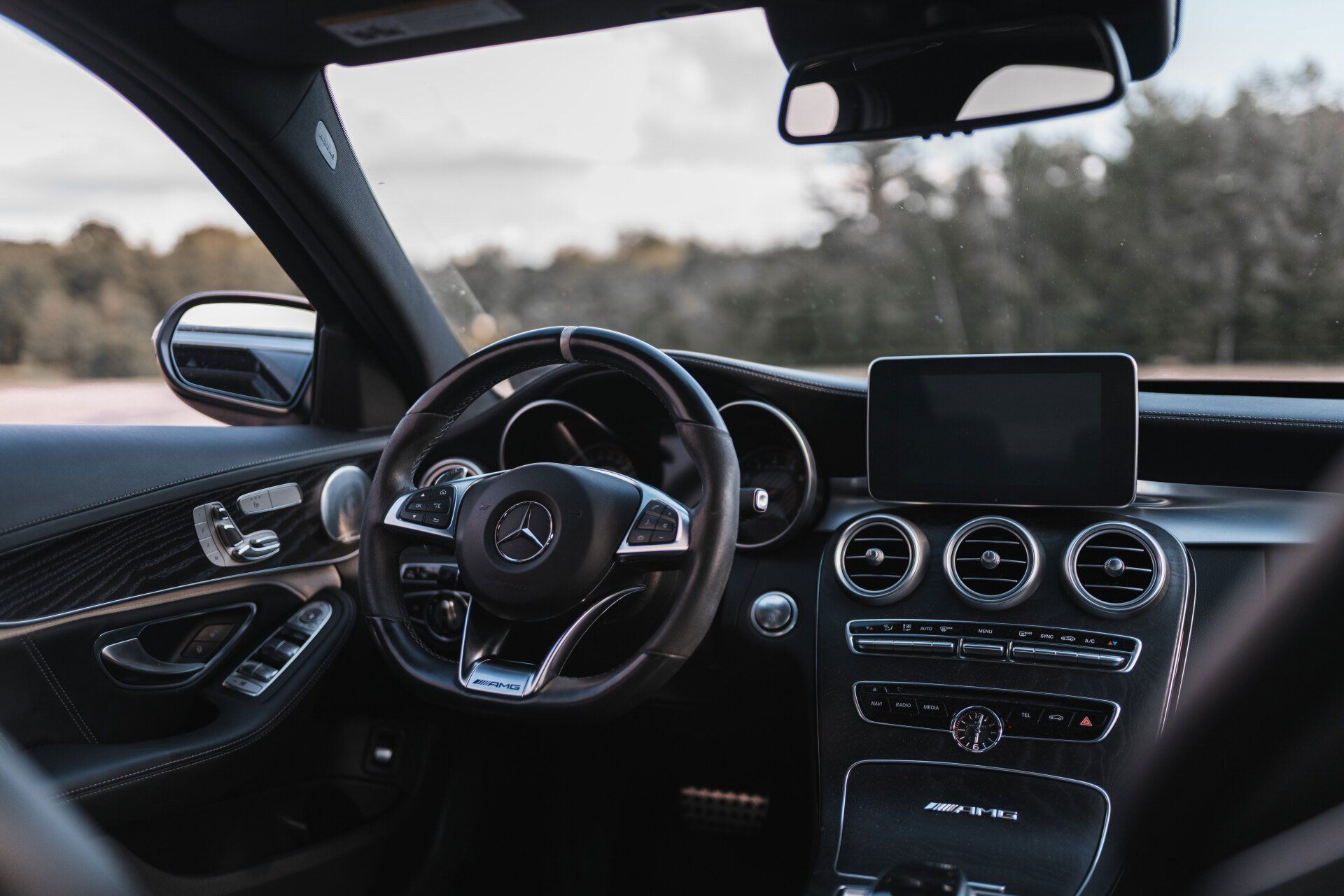 The inside of a car with a steering wheel and dashboard.