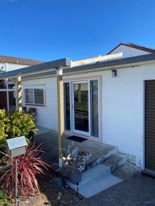A White House With a Porch and a Mailbox in Front of It — Superior Windows & Doors Taree, NSW