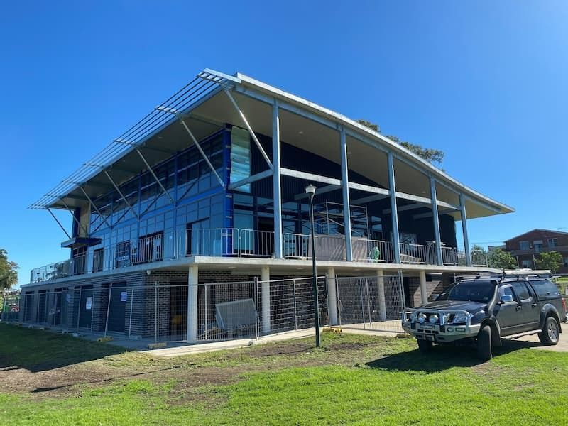 A Car is Parked in Front of a Large Building — Superior Windows & Doors Taree, NSW