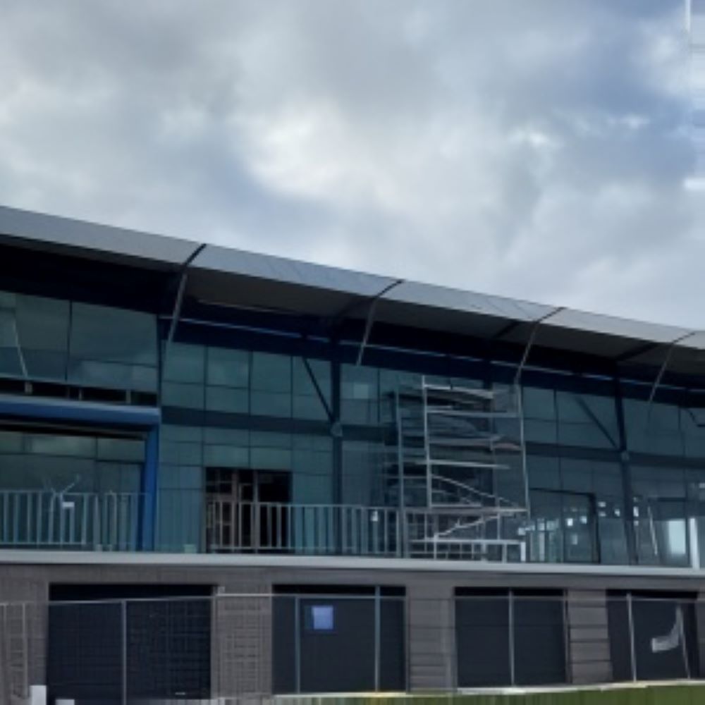 A Large Building With a Lot of Windows and a Fence Around It — Superior Windows & Doors Taree, NSW