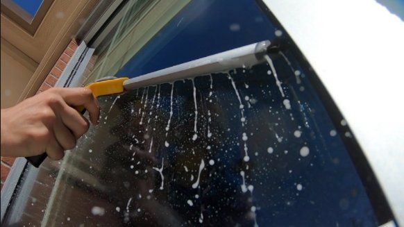 picture of a squeegee cleaning an exterior window