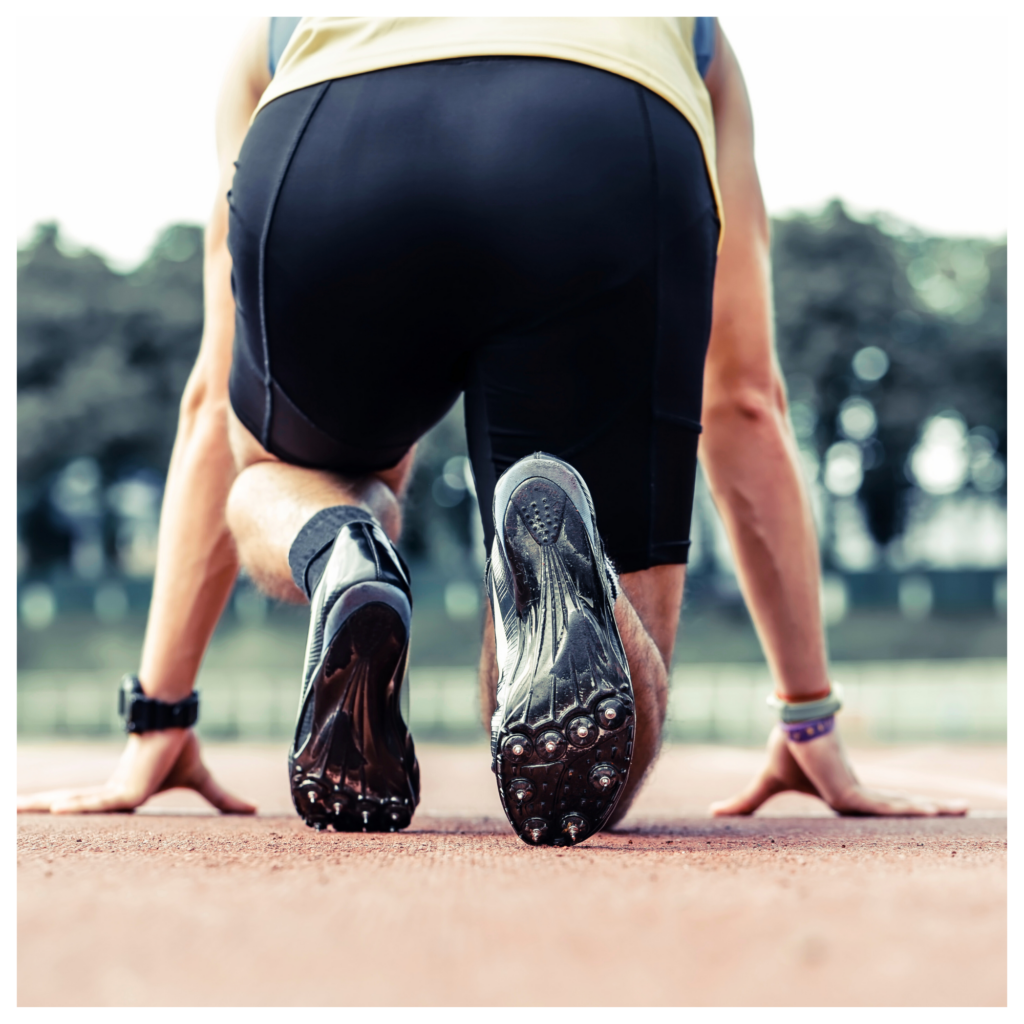 A person is getting ready to run on a track.