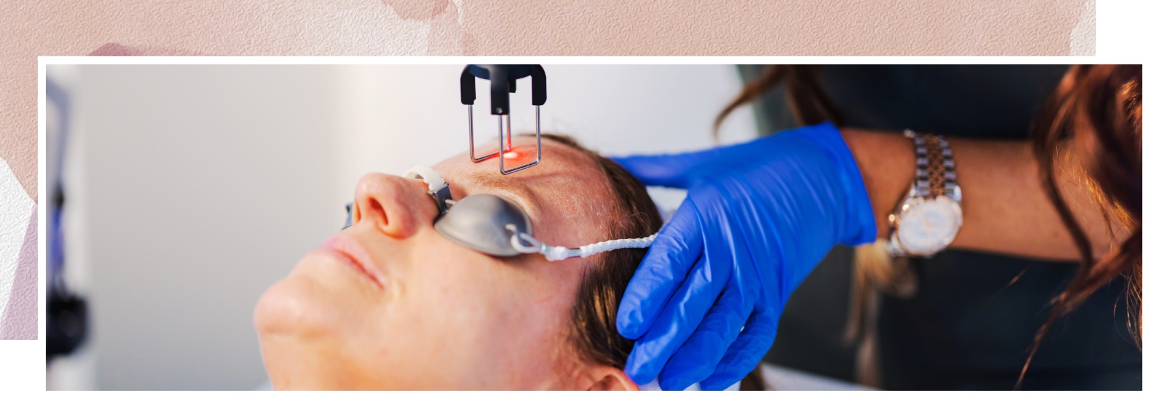 A woman is getting a laser treatment on her face.