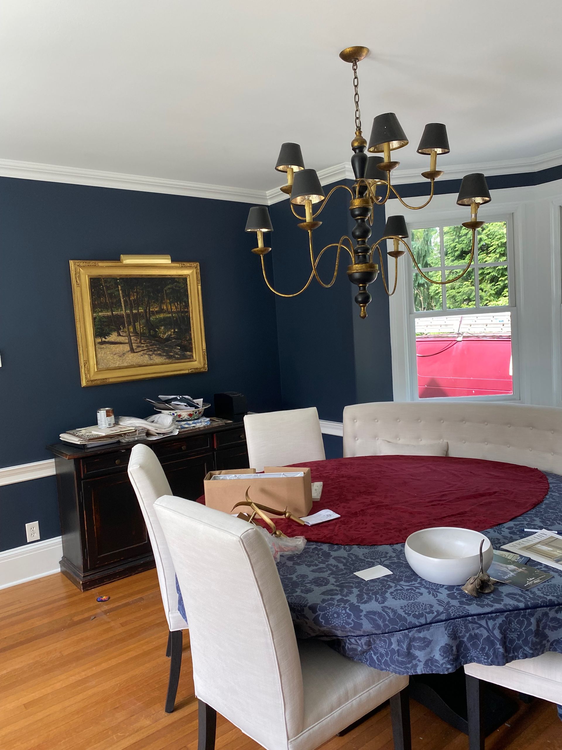 A dining room with a table and chairs and a chandelier