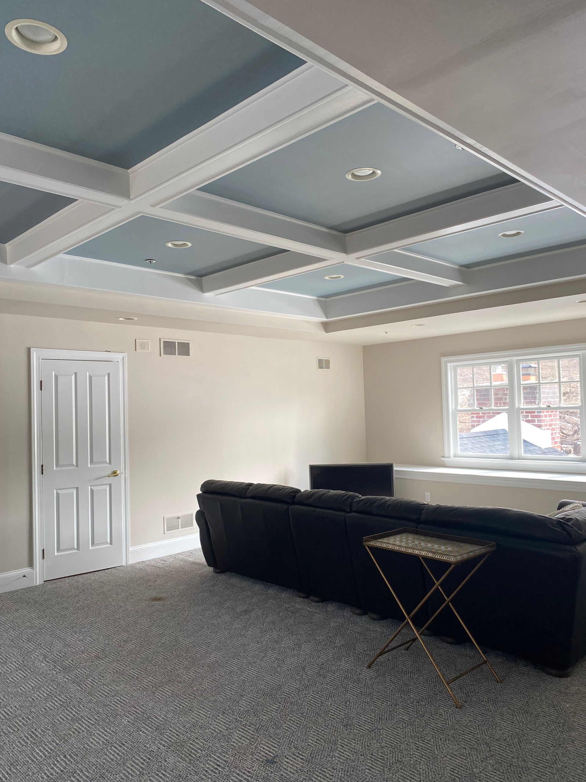 A living room with a couch and a table in it.