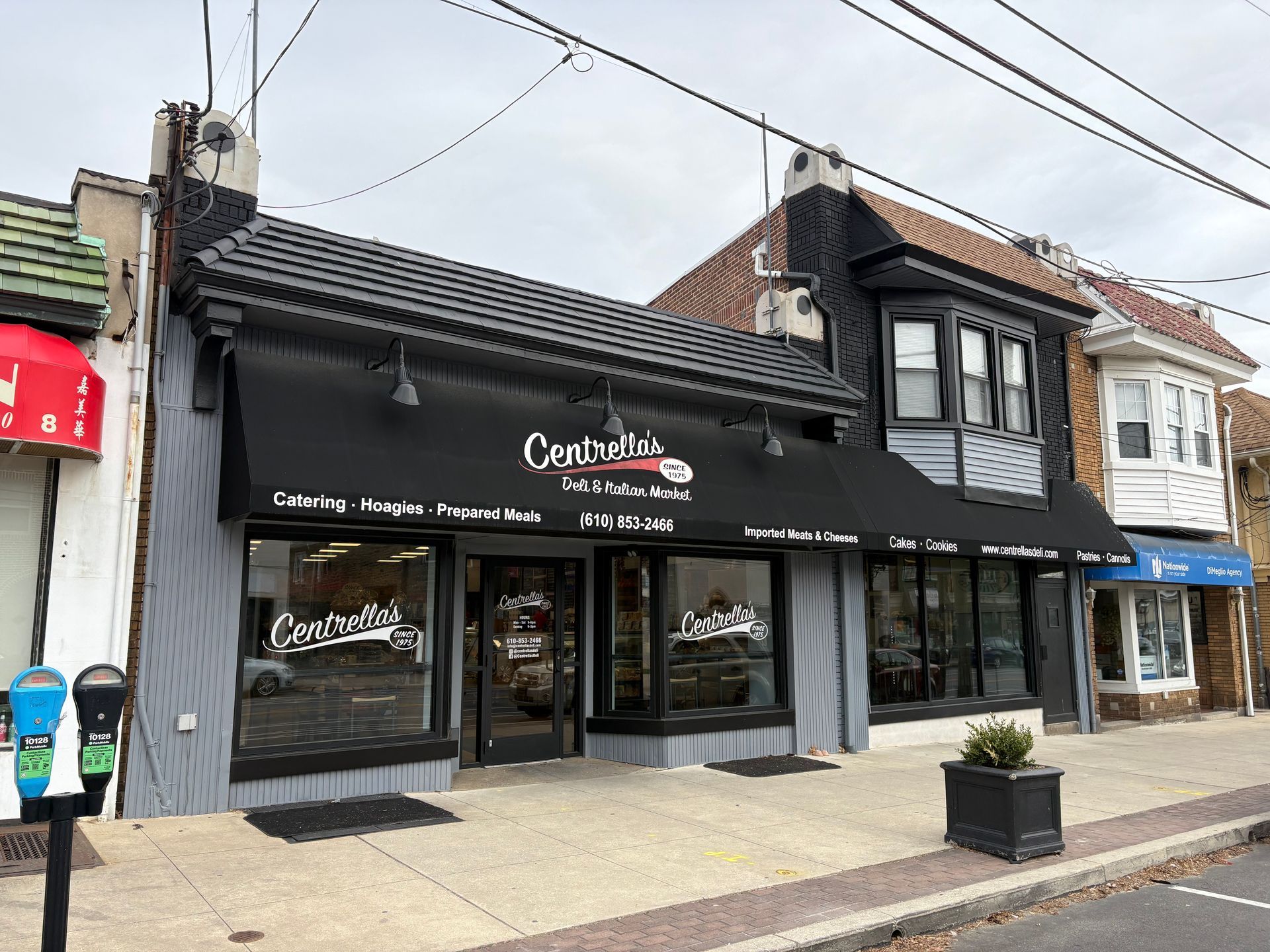 A building with a black awning on the side of it.