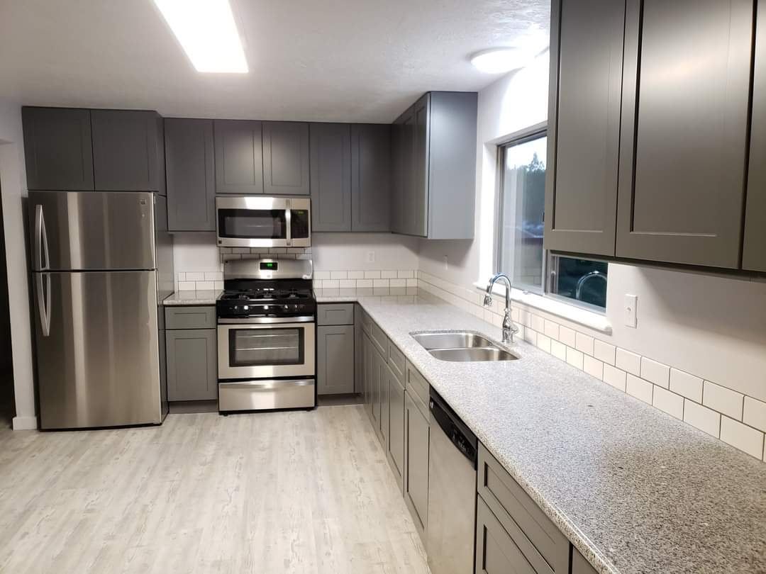 A kitchen with stainless steel appliances and granite counter tops