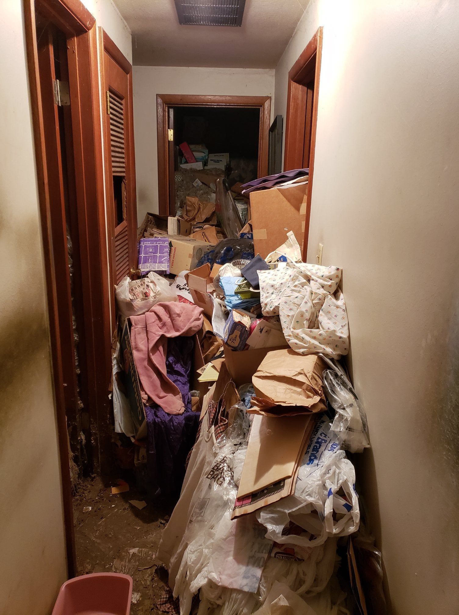 A hallway filled with lots of trash and boxes.