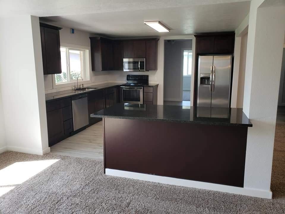 A kitchen with brown cabinets and stainless steel appliances