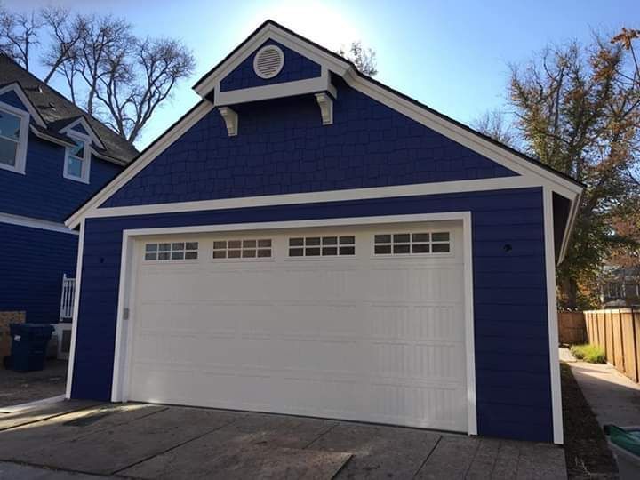 A blue house with a white garage door