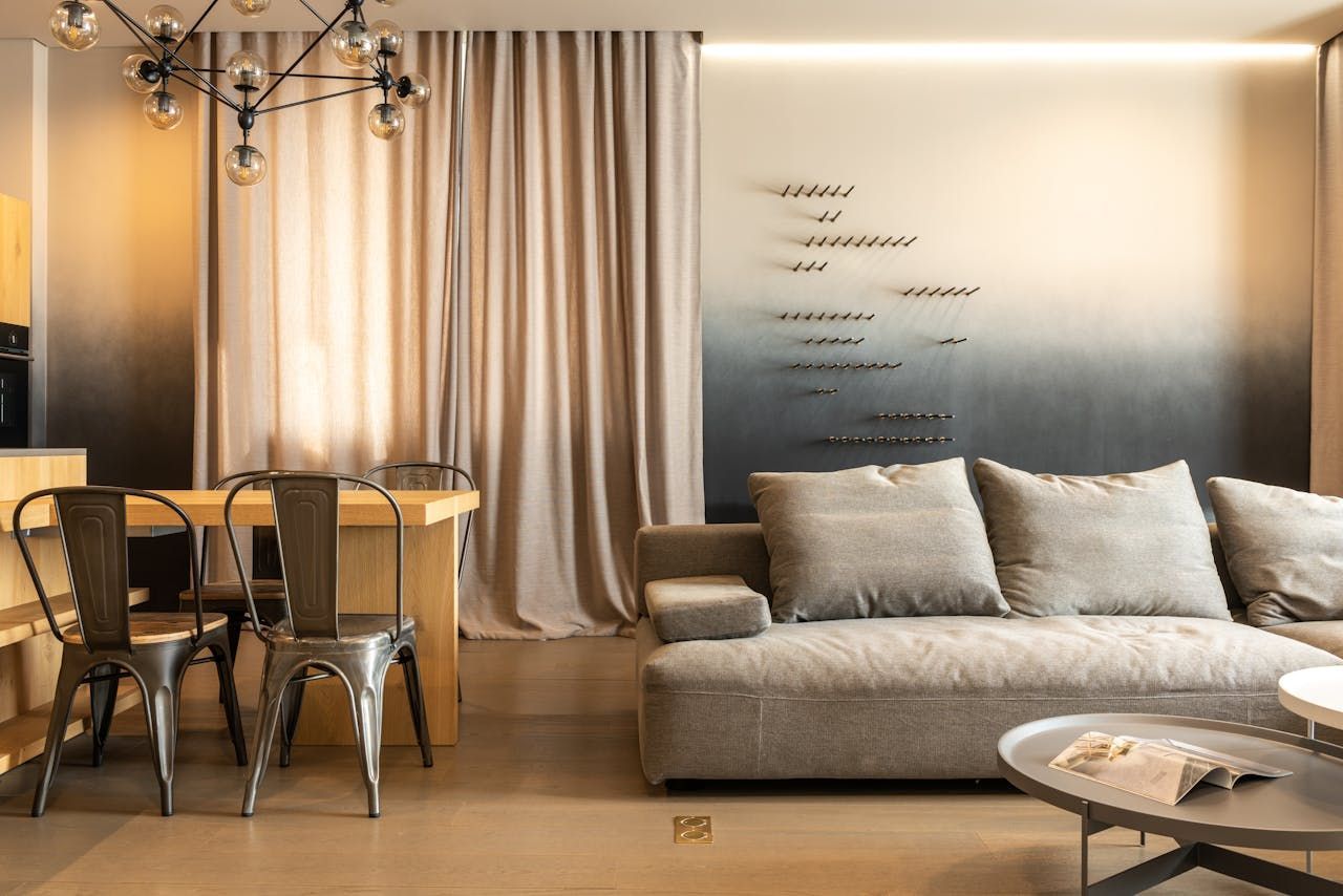 Ah living area of a house in cream and white color with an open kitchen