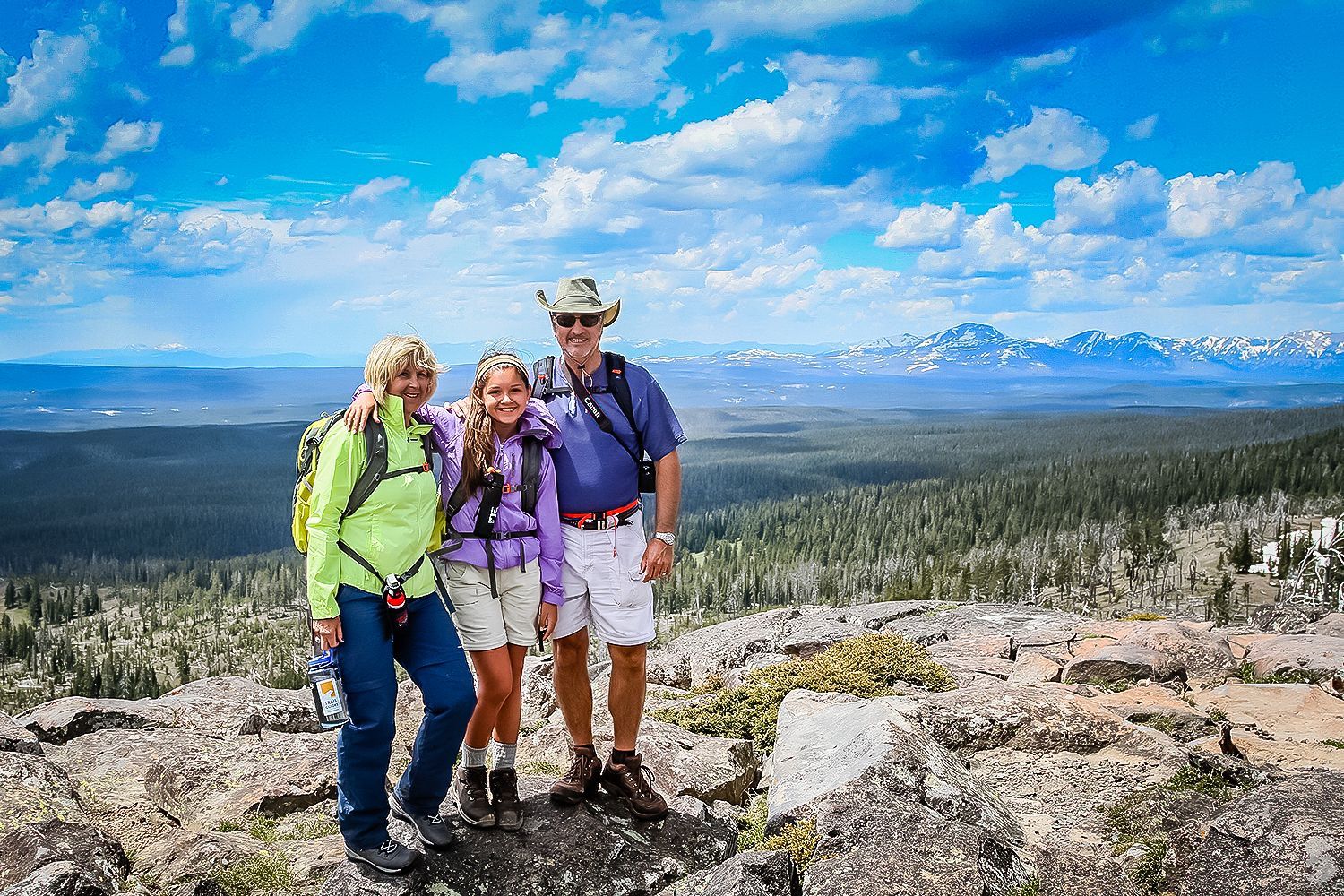 Day hikers celebrate the incredible view from the summit of Observation Peak in Yellowstone.