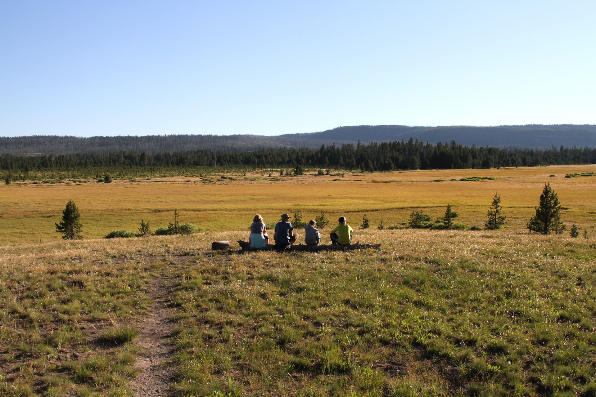 As the sun sets near campsite OD2, a family takes in the views of the Little Firehole Meadows.