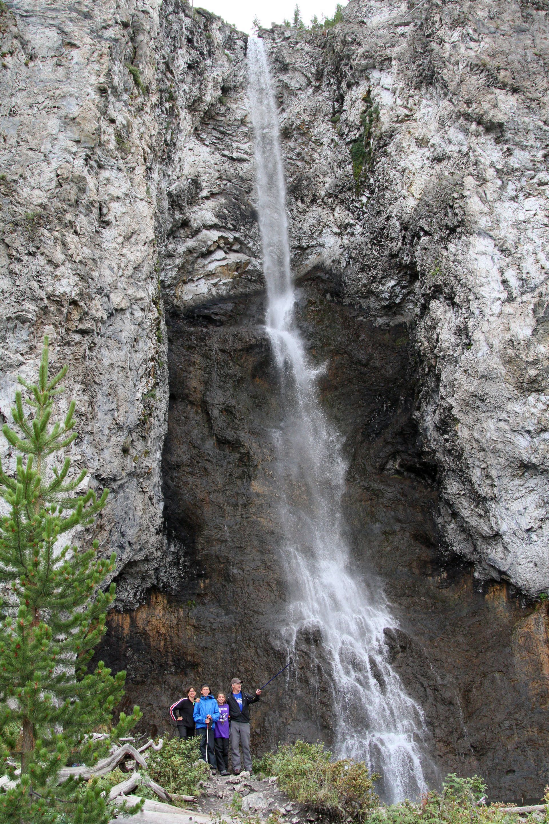 Fairy Falls is a popular destination for day hiking in Yellowstone. This delicate waterfall descends in feathery strands nearly 200 ft. from the plateau above.