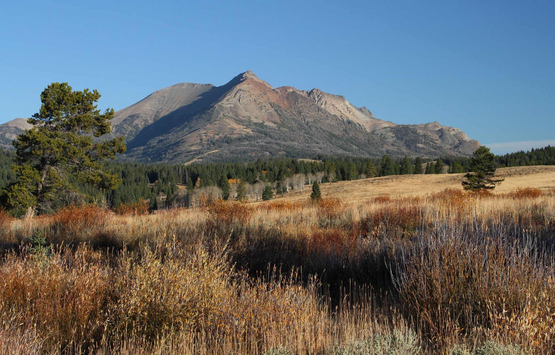 The early morning sun illuminates the flanks of Electric Peak on a crisp and clear fall day.