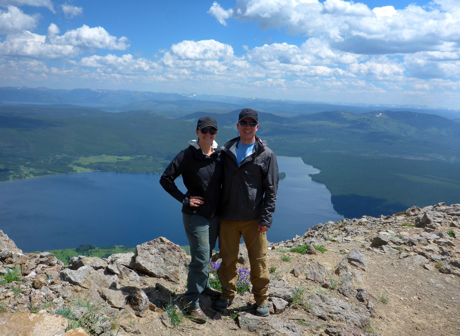 Day hikers enjoy the view from the summit of Mount Sheridan high above Heart Lake.