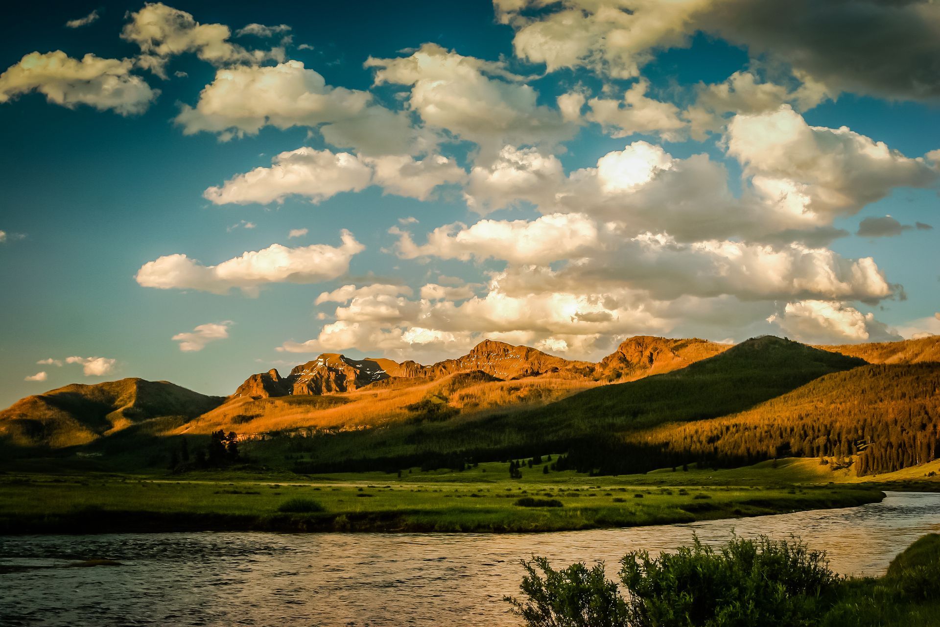 The rugged peaks along Yellowstone's northeast borders are turned a vibrant orange by the setting sun.