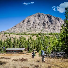 Backpackers approach the Thorofare Ranger Station in the remote southeastern corner of Yellowstone National Park.