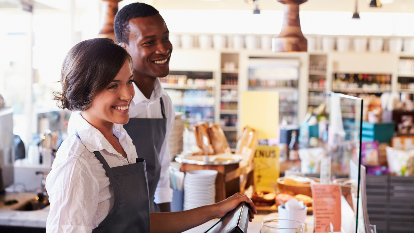 a man and a woman are working in a restaurant .