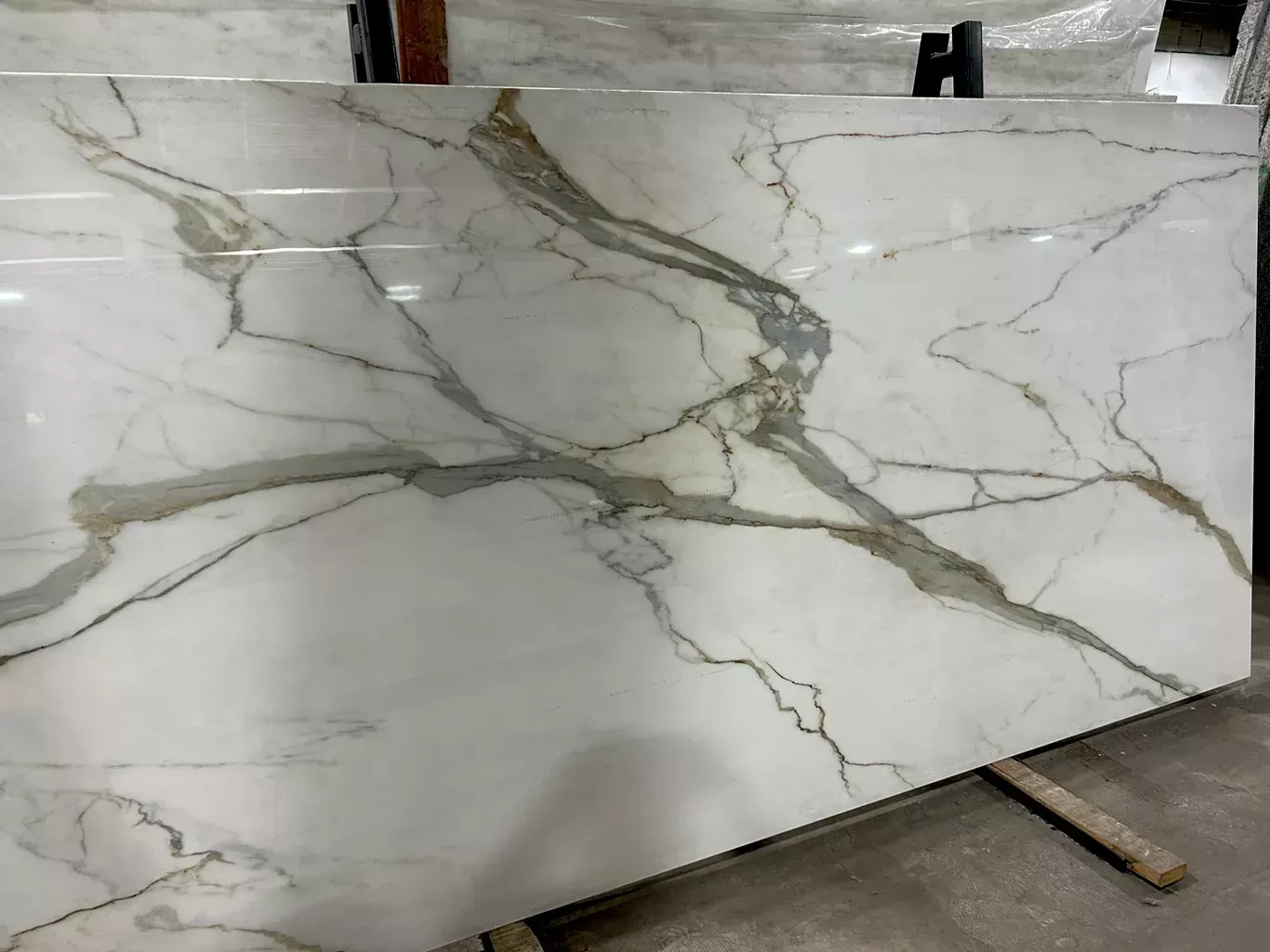 A large white marble slab is sitting on top of a wooden table.