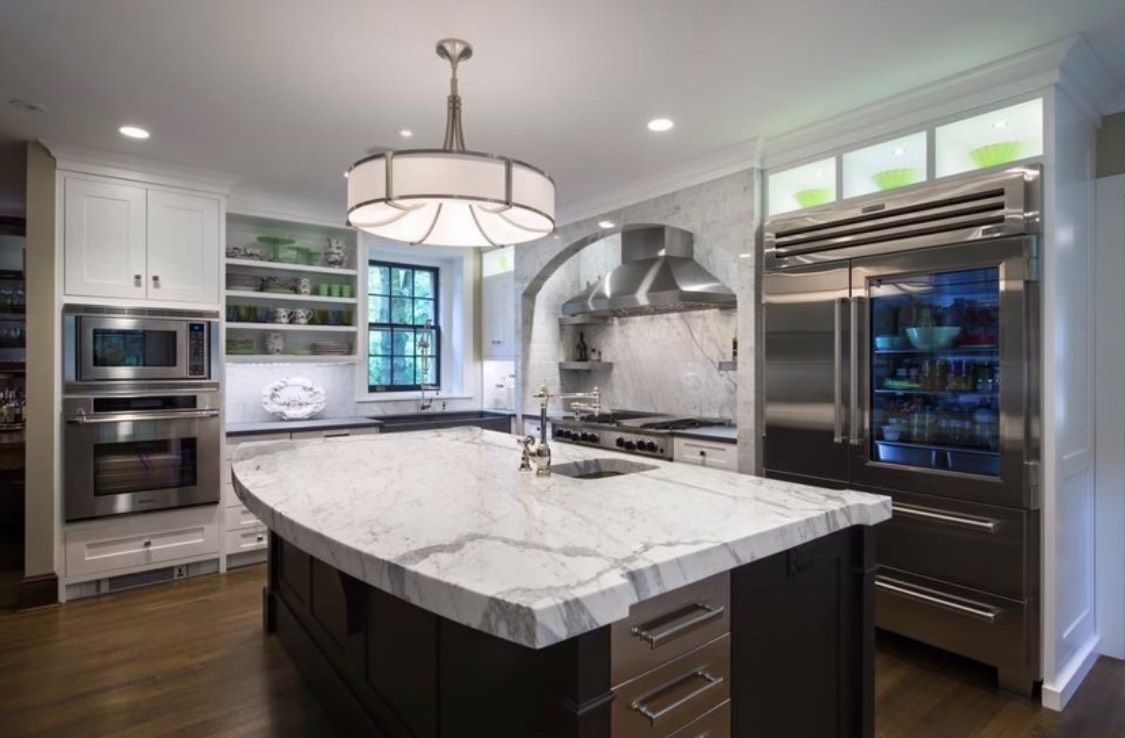 There is a large island in the middle of the kitchen.