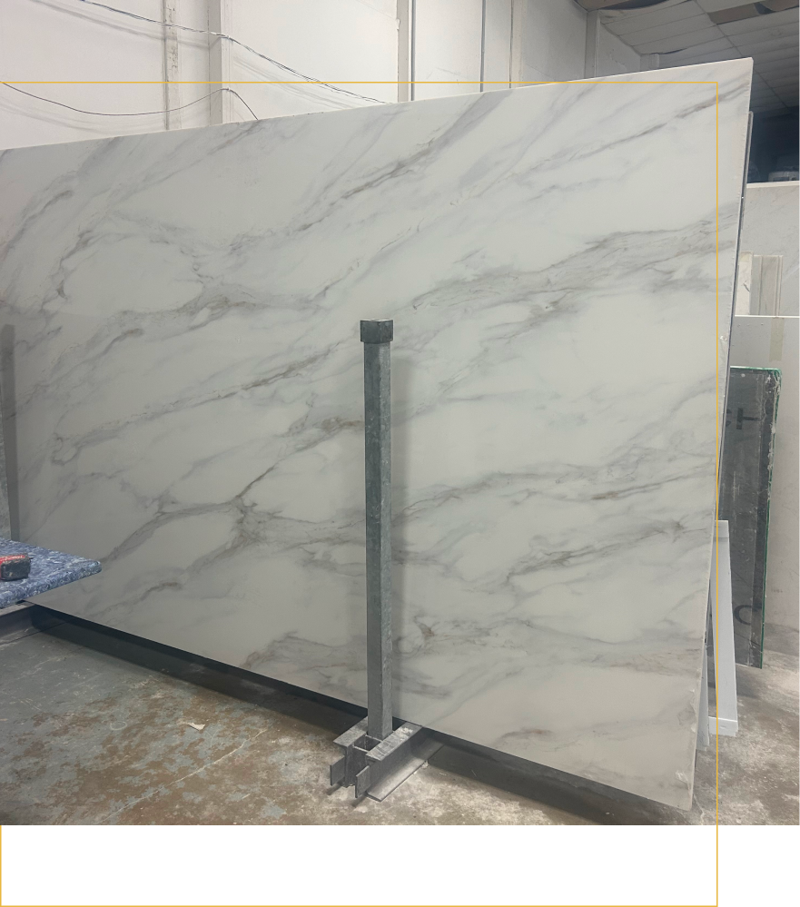 A kitchen with white cabinets , a sink , an oven , and a window.