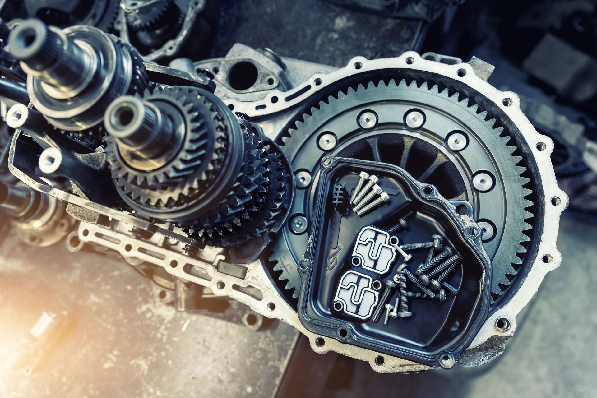 Close-up of exposed car transmission gears and clutch assembly in metallic silver and black | Cruz-N-Carz