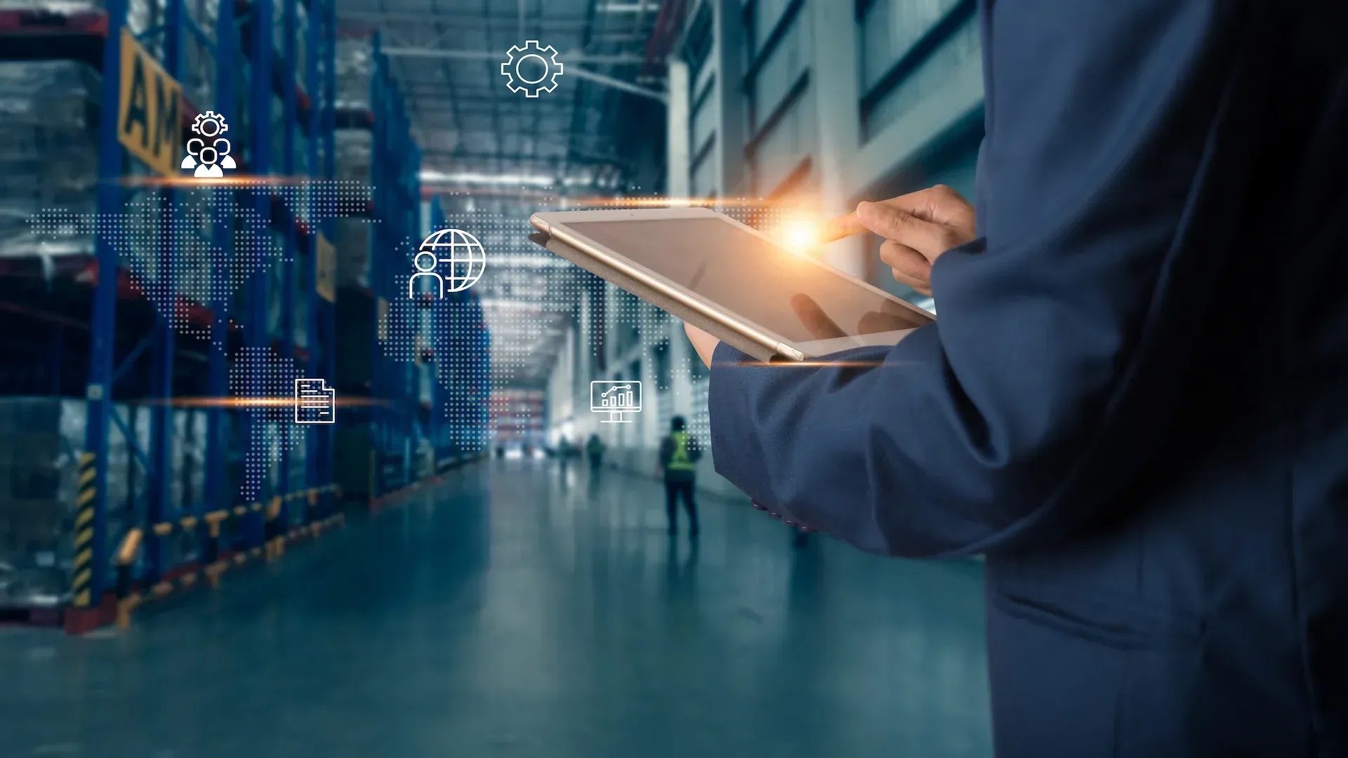A person in a stainless steel custom made warehouse in Malaysia setting uses a tablet that displays 