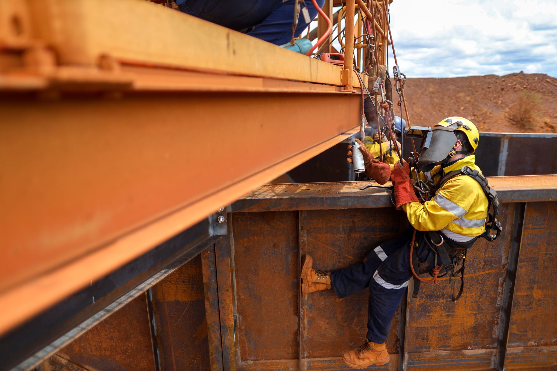 Technician applying metal spray coating to steel structure