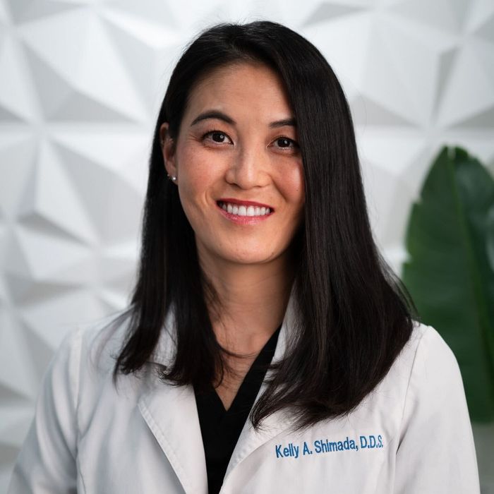 Woman in white lab coat smiles; text reads