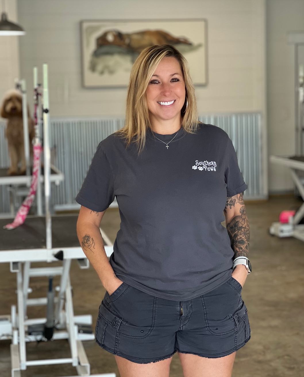 A woman is standing in a room with her hands in her pockets.