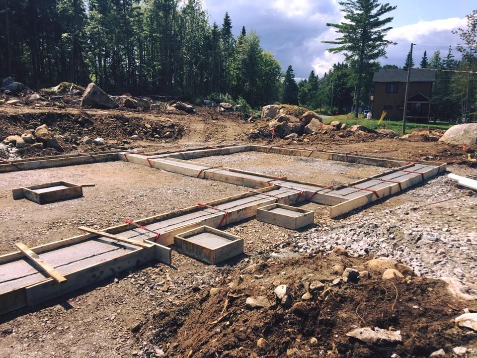 Un chantier de construction avec une maison en arrière-plan