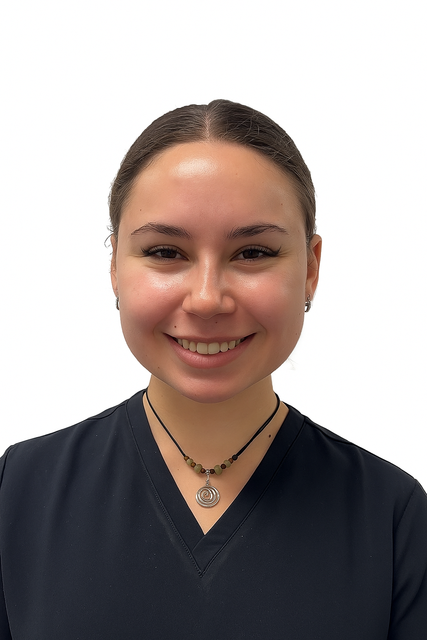 A woman wearing a black shirt and a necklace is smiling for the camera.