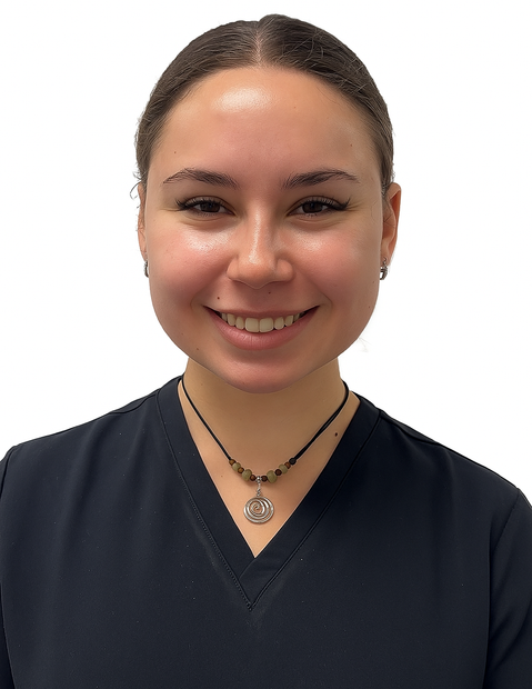 Smiling woman in a dark blue top and necklace, against a white background.