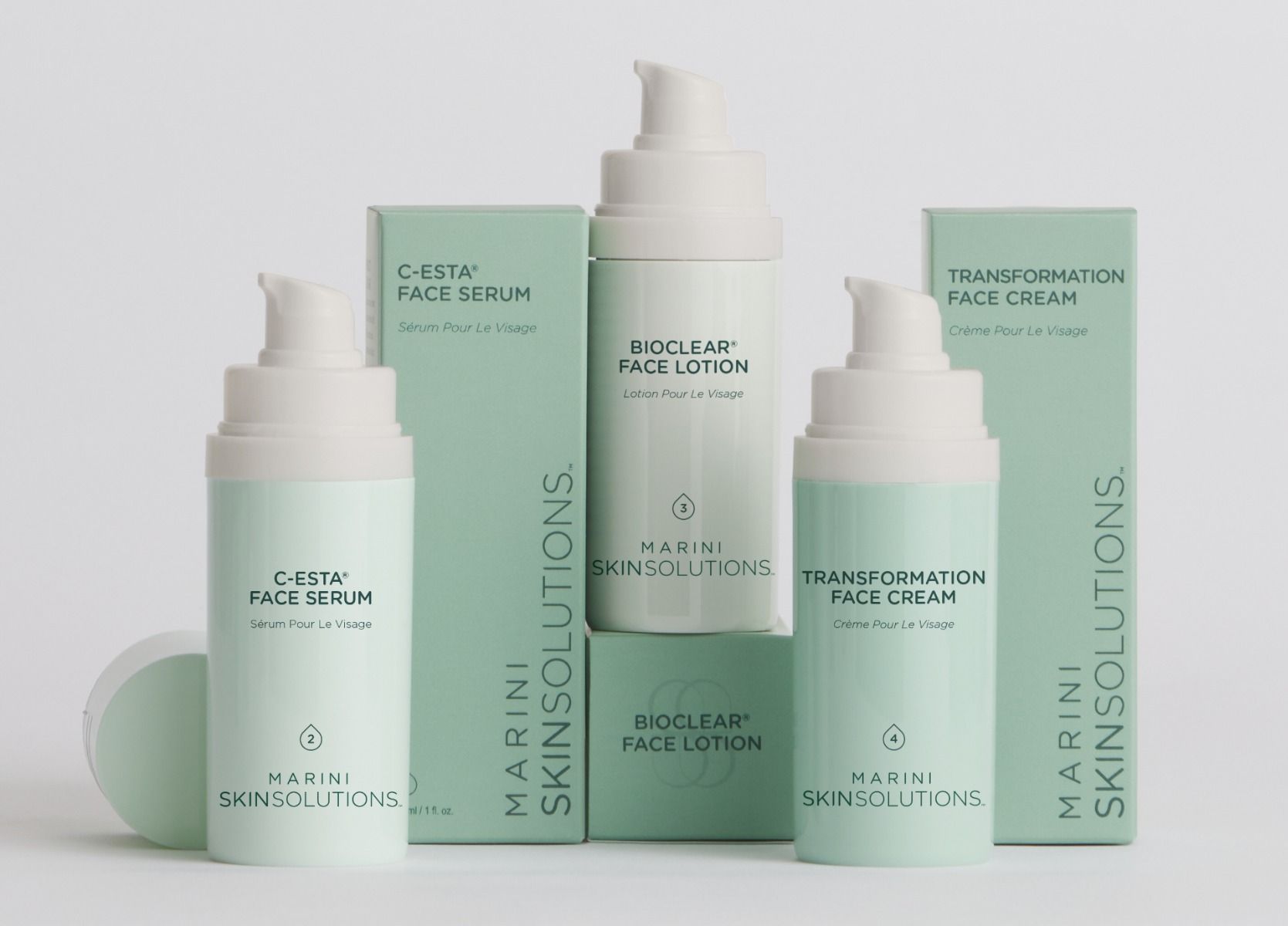 Cosmetic skincare products by Marini Skin Solutions in mint green packaging.