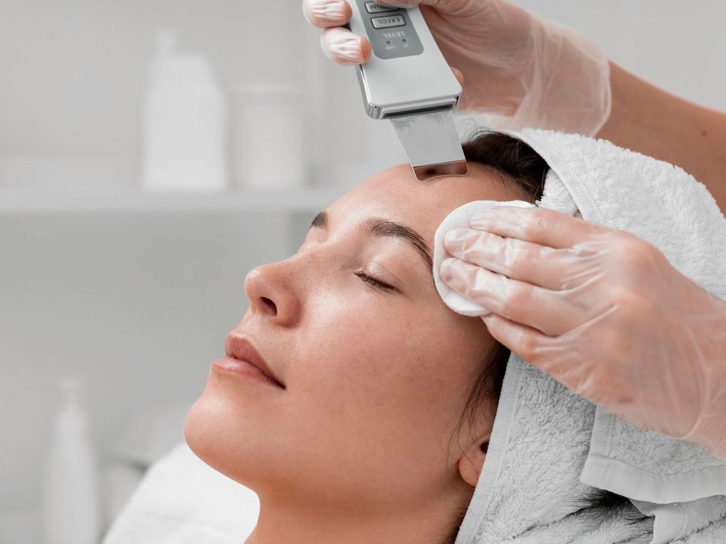 a woman is getting a facial treatment with a device that says ' ultrasonic ' on it