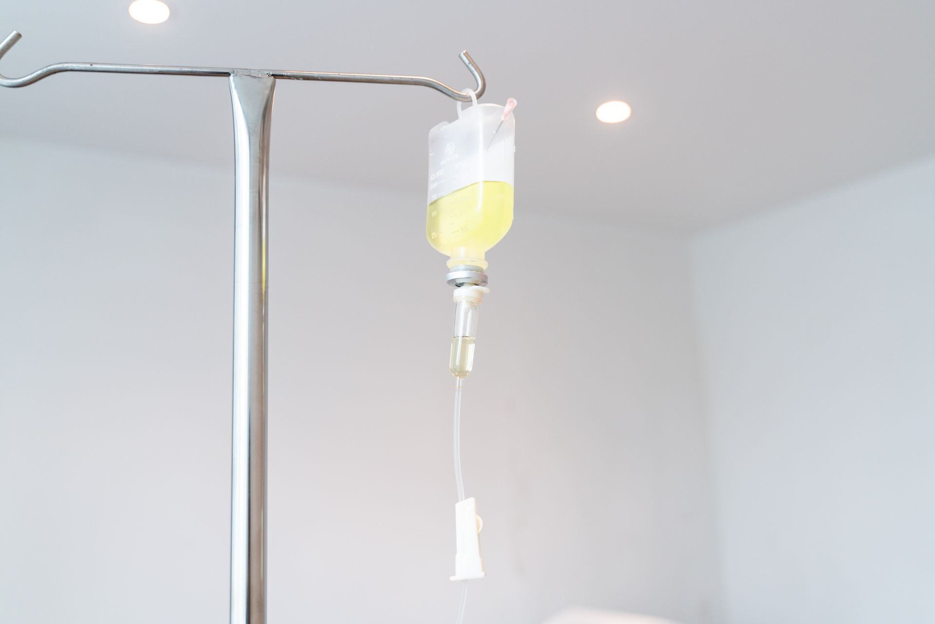 a drip with a yellow liquid hanging from it
