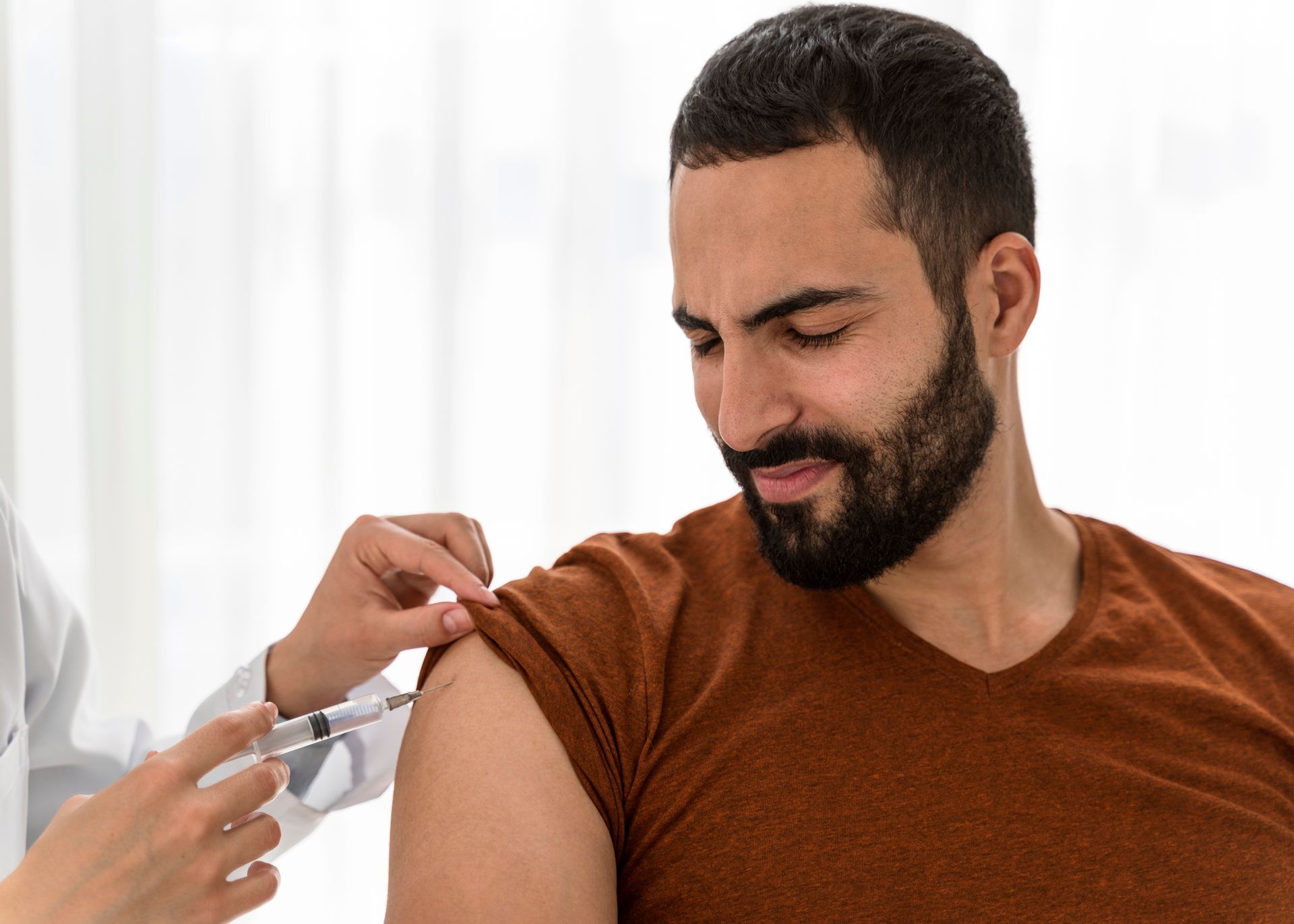 a man is getting an injection in his arm