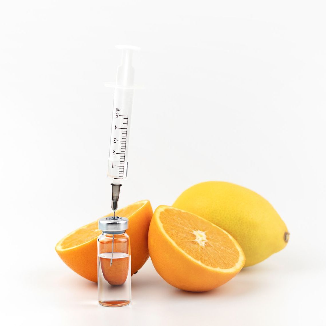 a syringe is being used to inject a bottle of orange juice