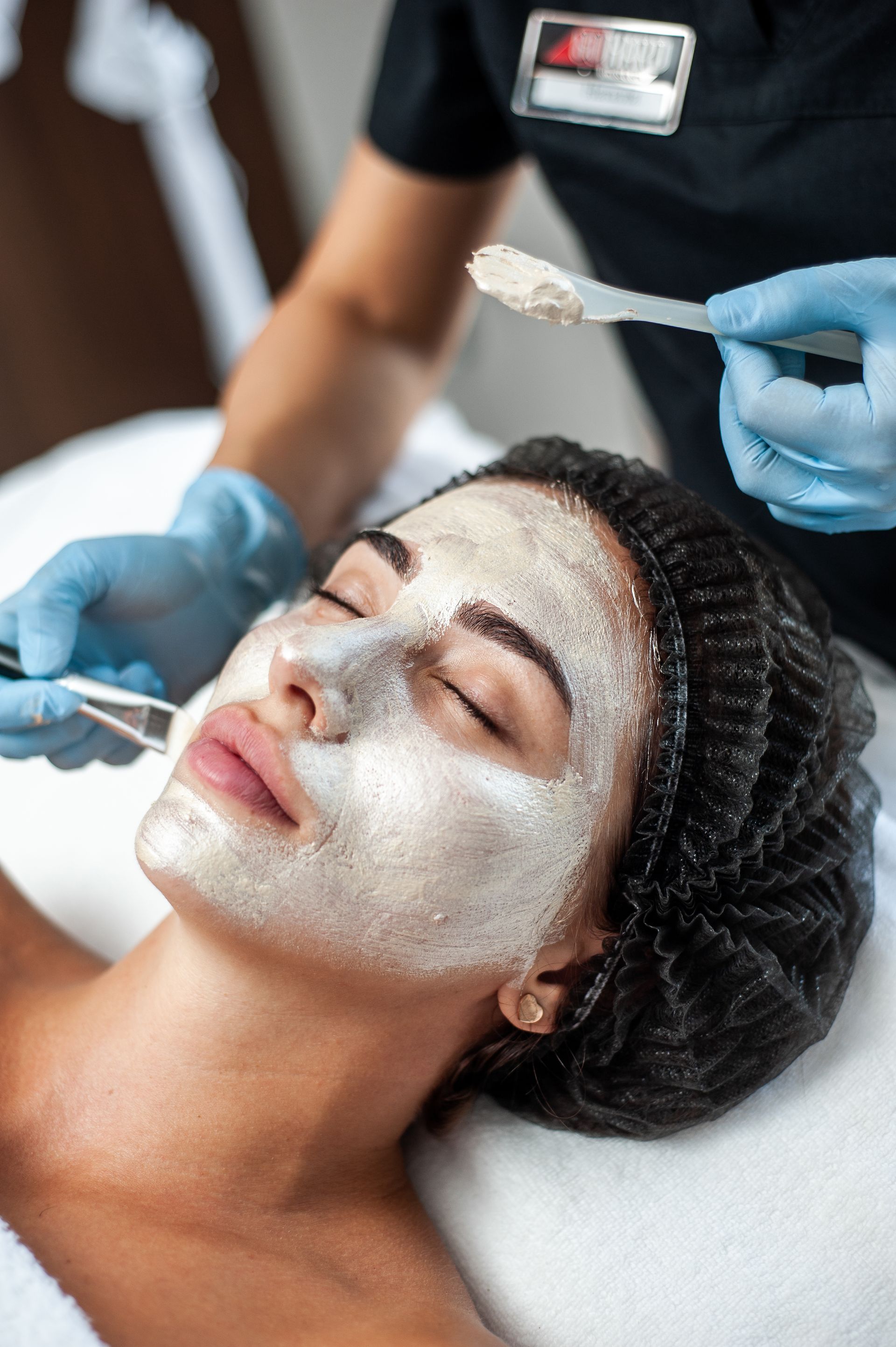 A woman is getting a facial treatment at a spa.