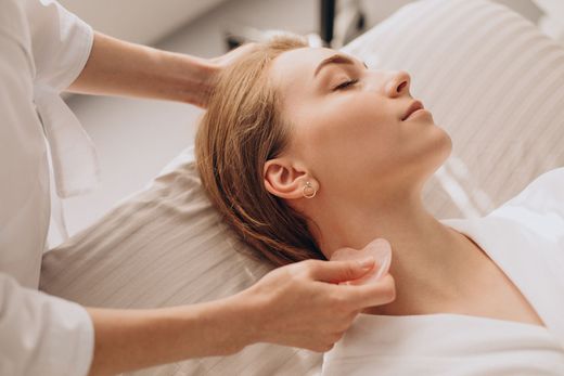 a woman with a ring in her ear is getting a massage