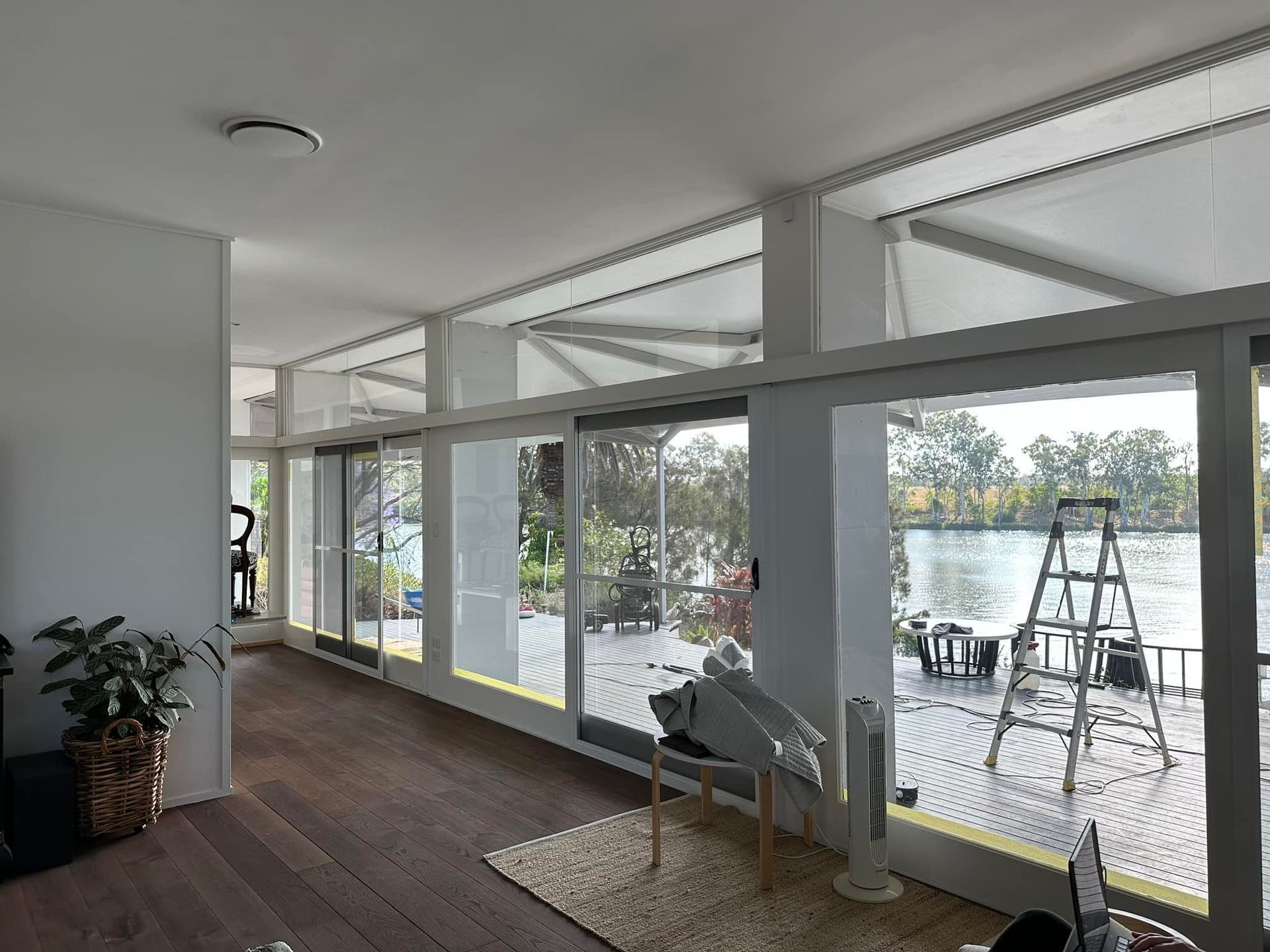 Interior With Large Windows Overlooking a Waterfront Deck — Wide Bay Tinting in Childers, QLD