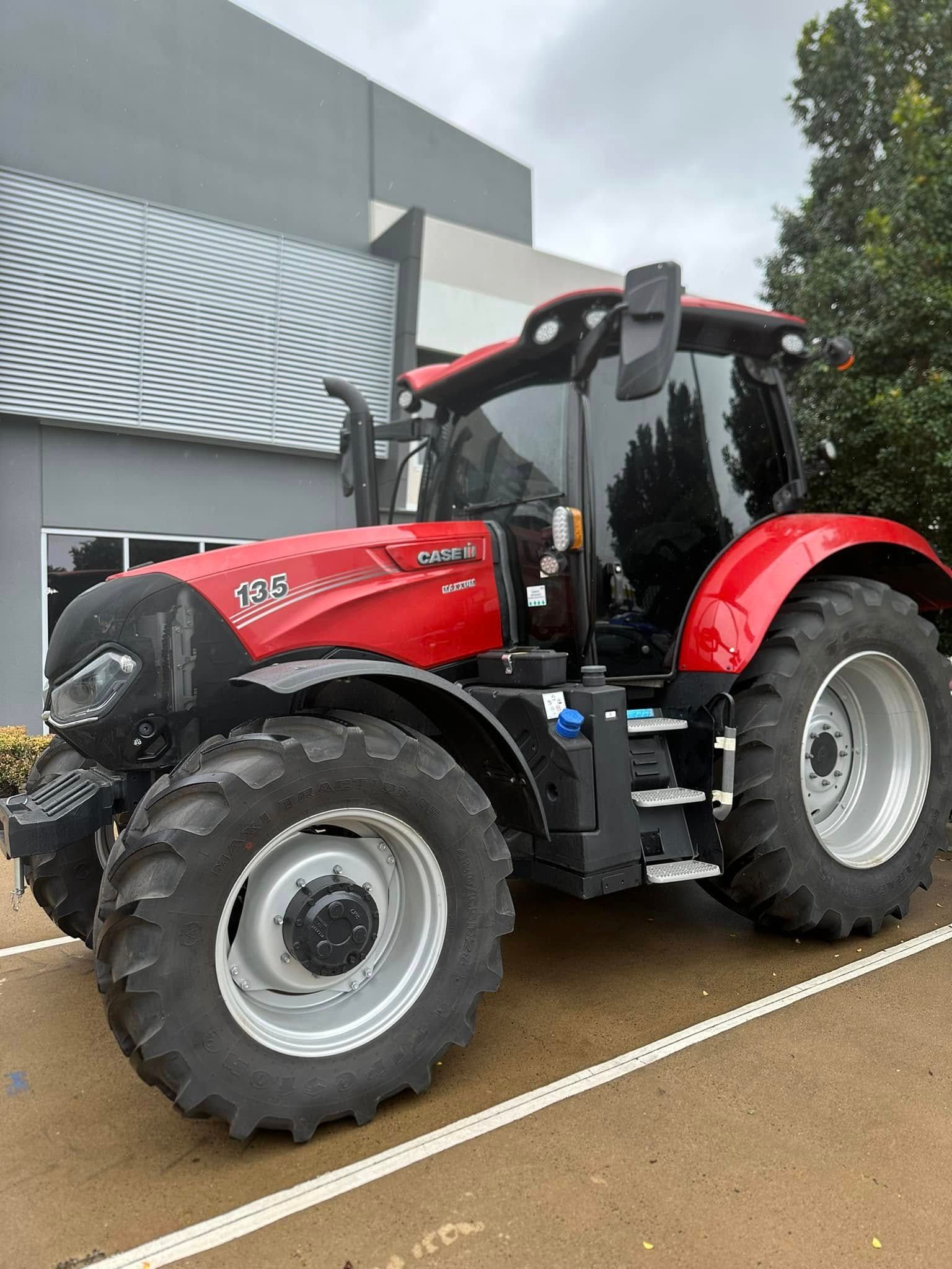 Red Case IH Puma 185 Tractor Parked Outside a Modern Building — Wide Bay Tinting in Bargara, QLD