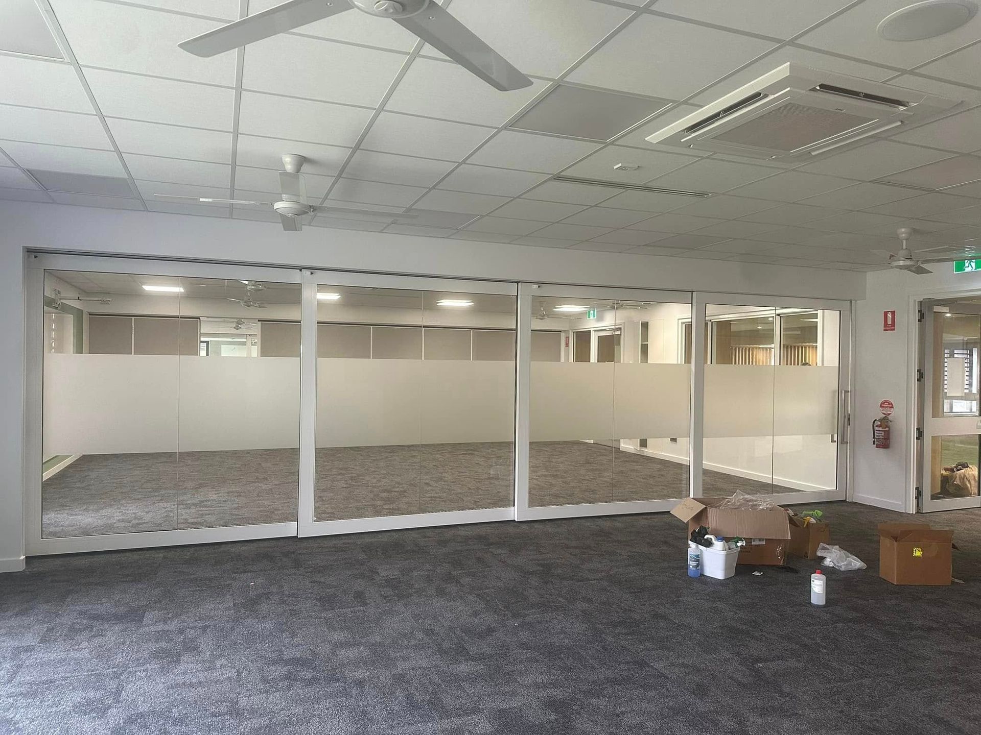 A Room With a Closed, Frosted Glass and White-framed Partition — Wide Bay Tinting in Bargara, QLD