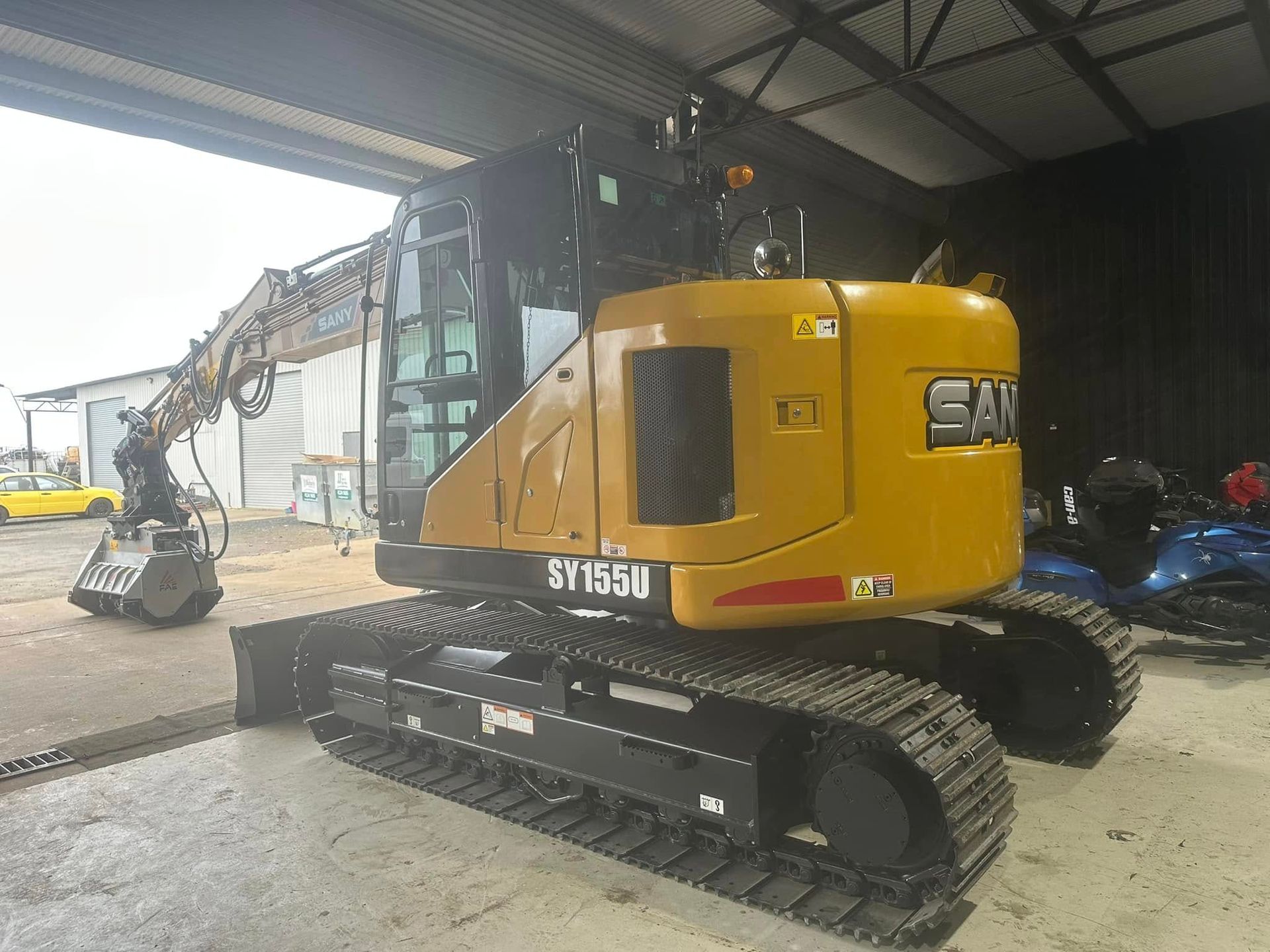 Yellow Caterpillar excavator, SF165M model — Wide Bay Tinting in Kensington, QLD