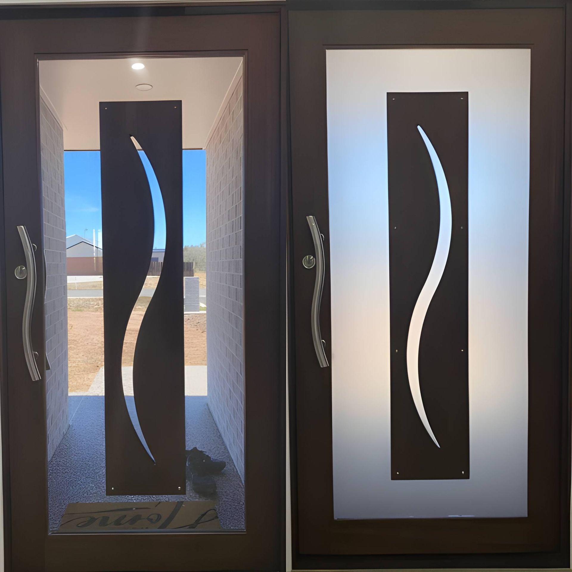 Two Brown Entry Doors With Curved Metal Designs — Wide Bay Tinting in Kensington, QLD