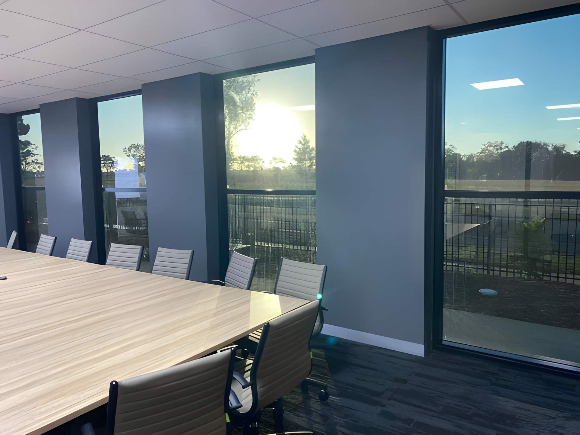 Conference Room With Large Windows Overlooking a Sunny Outdoor Scene — Wide Bay Tinting in Kensington, QLD