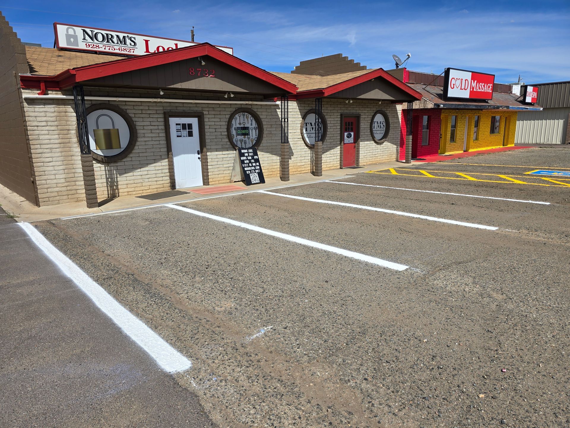 Two white arrows painted on dark asphalt point in opposite directions, indicating opposing lanes of traffic.